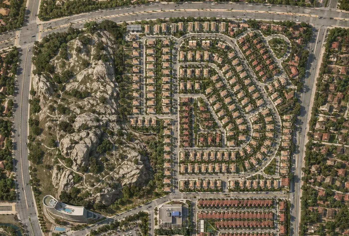 Aerial masterplan of a Zyadd district development, residential clusters planned around a natural rock outcrop